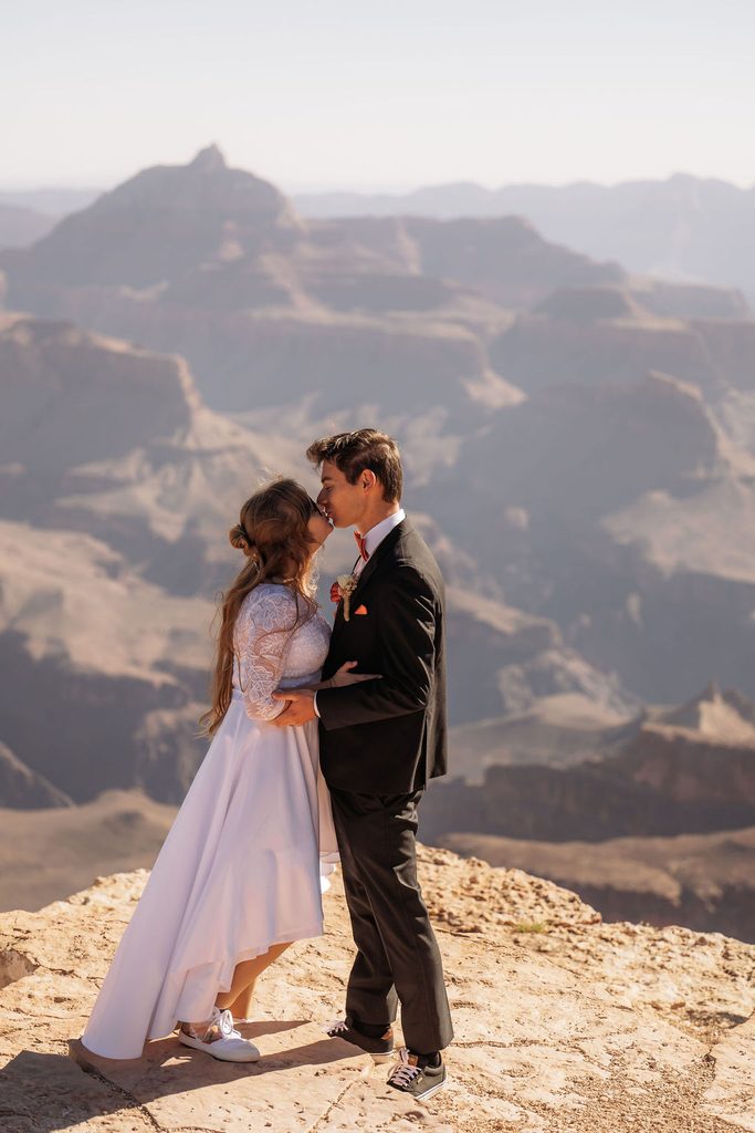 couple kisses at Grand Canyon overlook