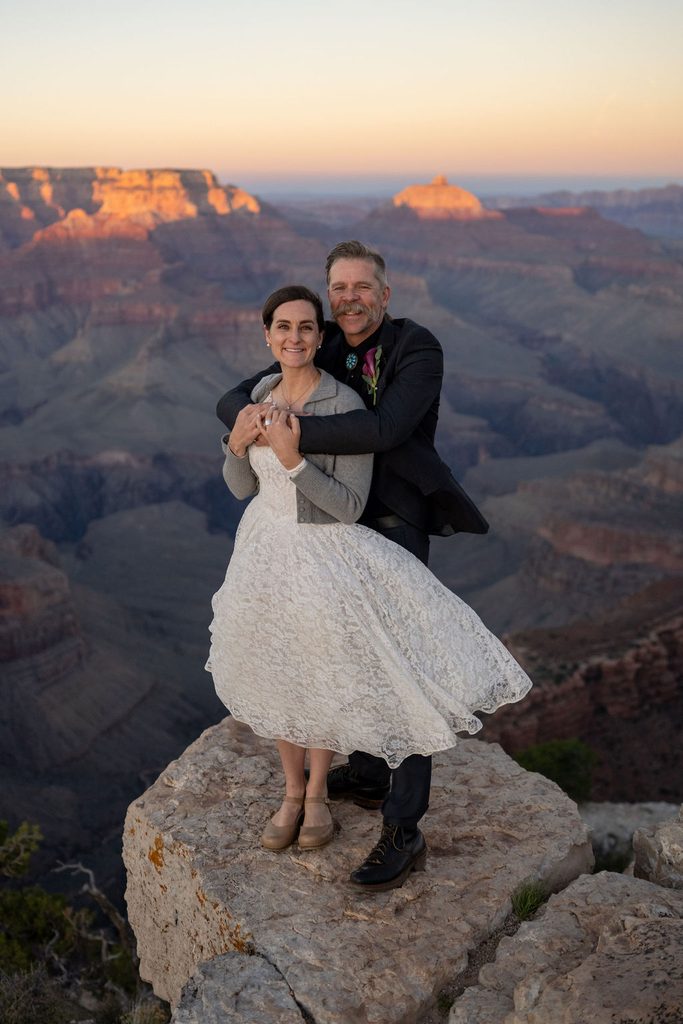couple embraces at Grand Canyon overlook