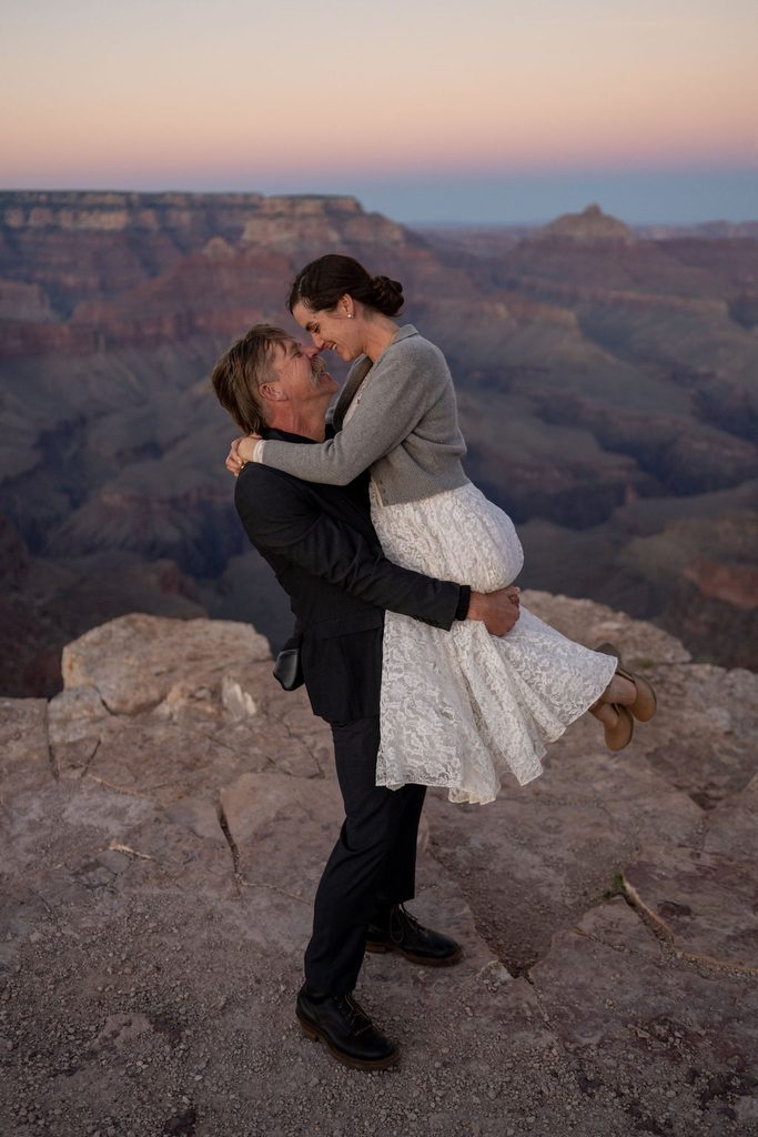 couple embraces at Grand Canyon overlook