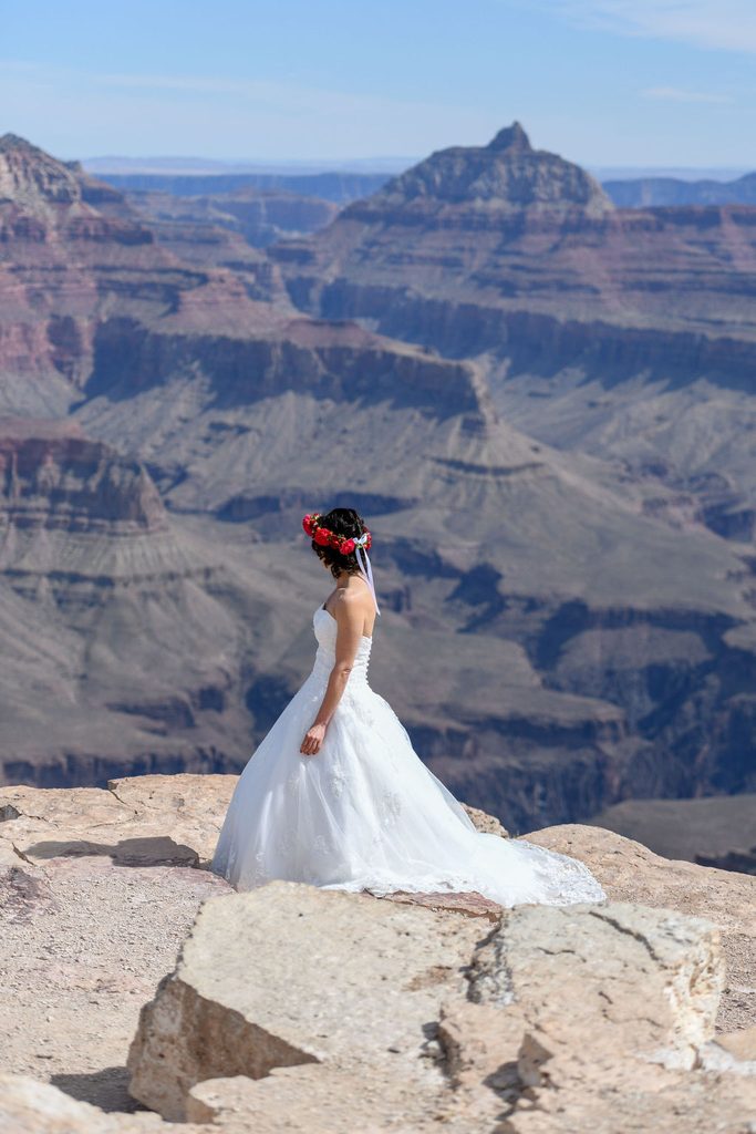 bride walks along edge at Grand Canyon
