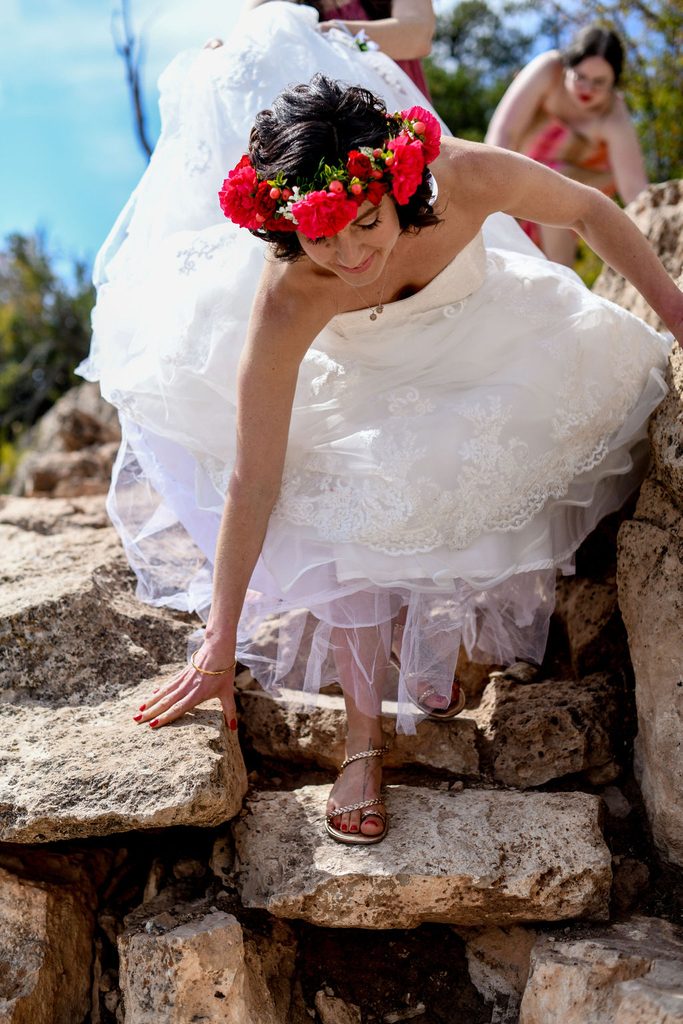 bride walks on rocky terrain 