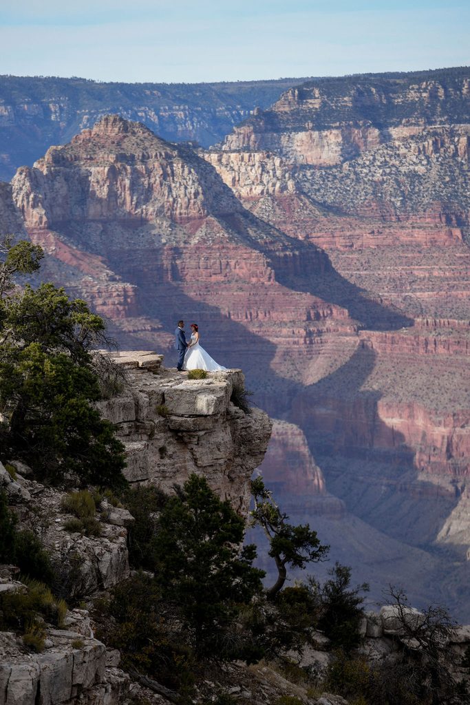 couple stands on overlook at Grand Canyon Shoshone Point