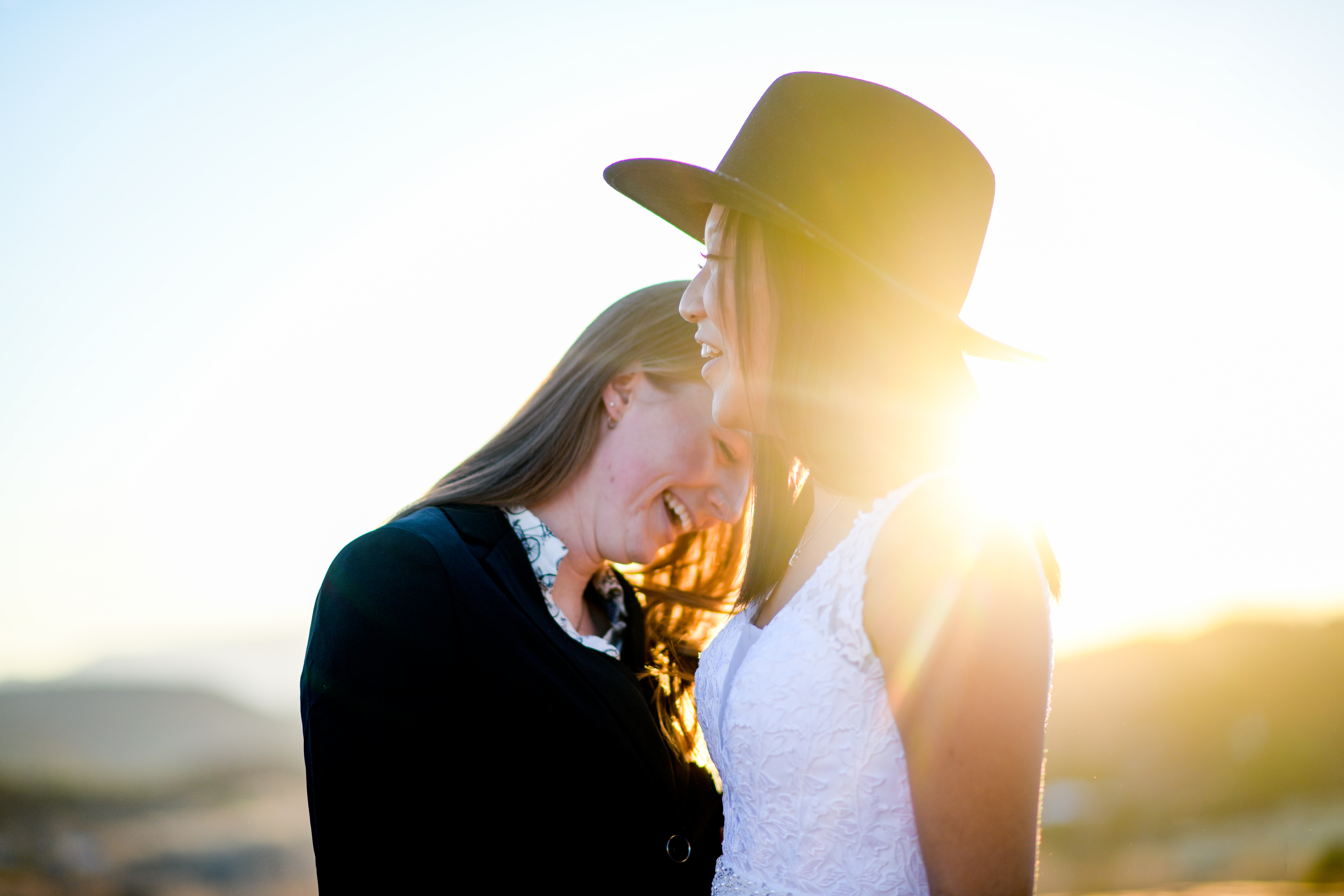 couple laughing together during sunrise
