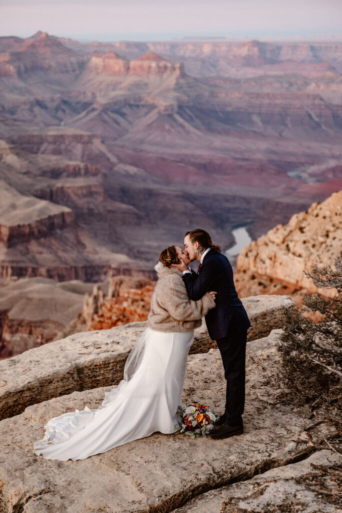 couple embraces at grand canyon elopement