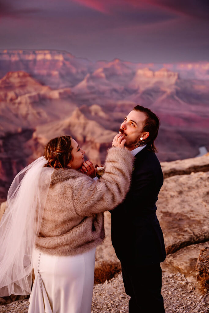 couple eats wedding cake