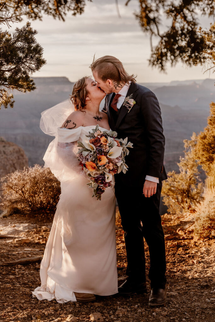 couple kisses at sunset elopement