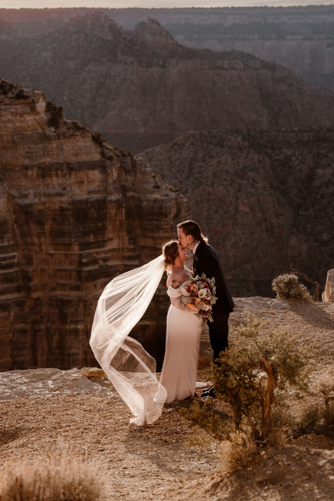couple kisses at Grand Canyon winter elopement