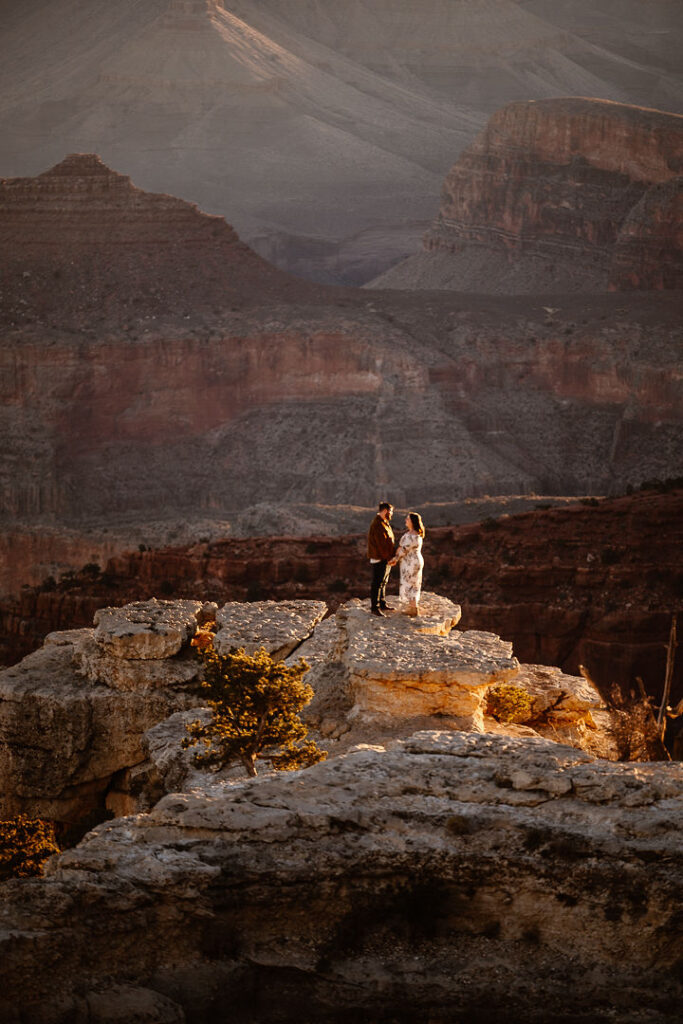 couple stands on overlook at Grand Canyon engagement session