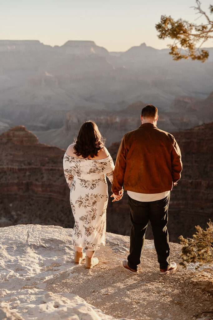 couple holds hands at winter engagement photos