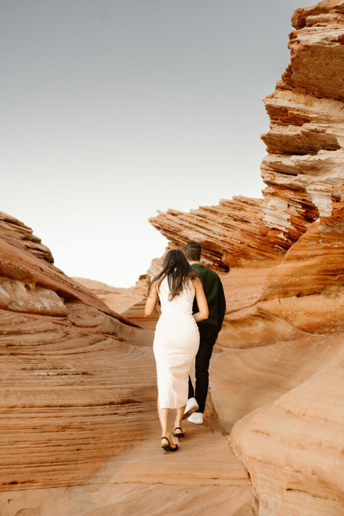 couple walks along Arizona terrain