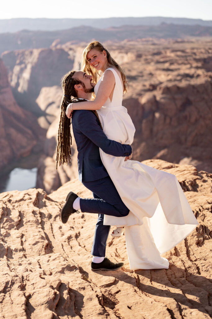 couple embraces at horseshoe bend elopement