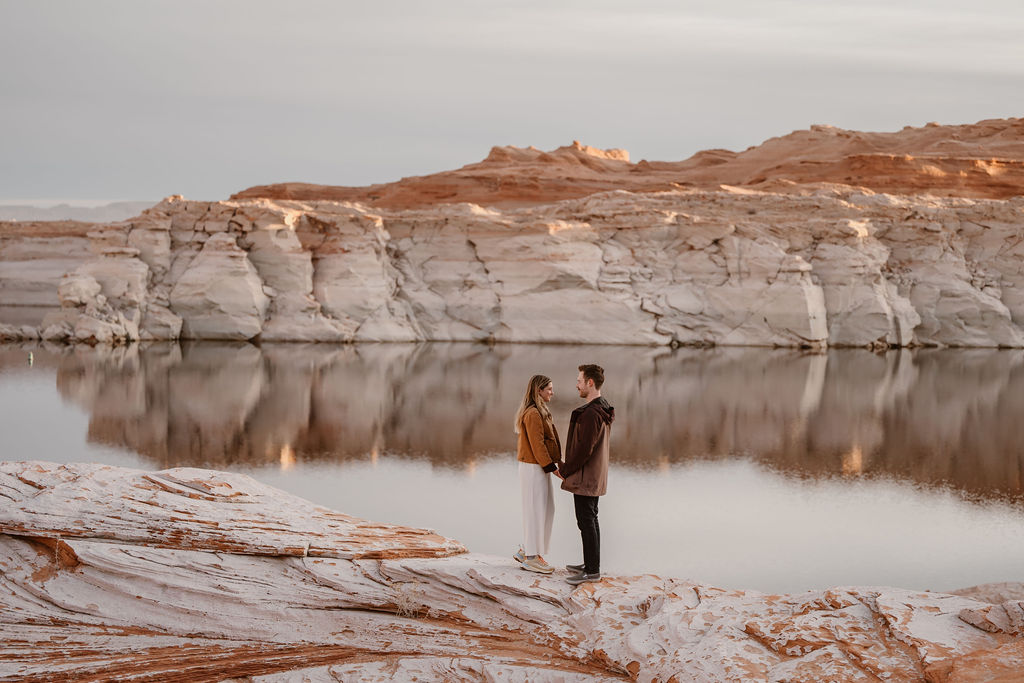 couple holds hands at Lake Powell engagement session