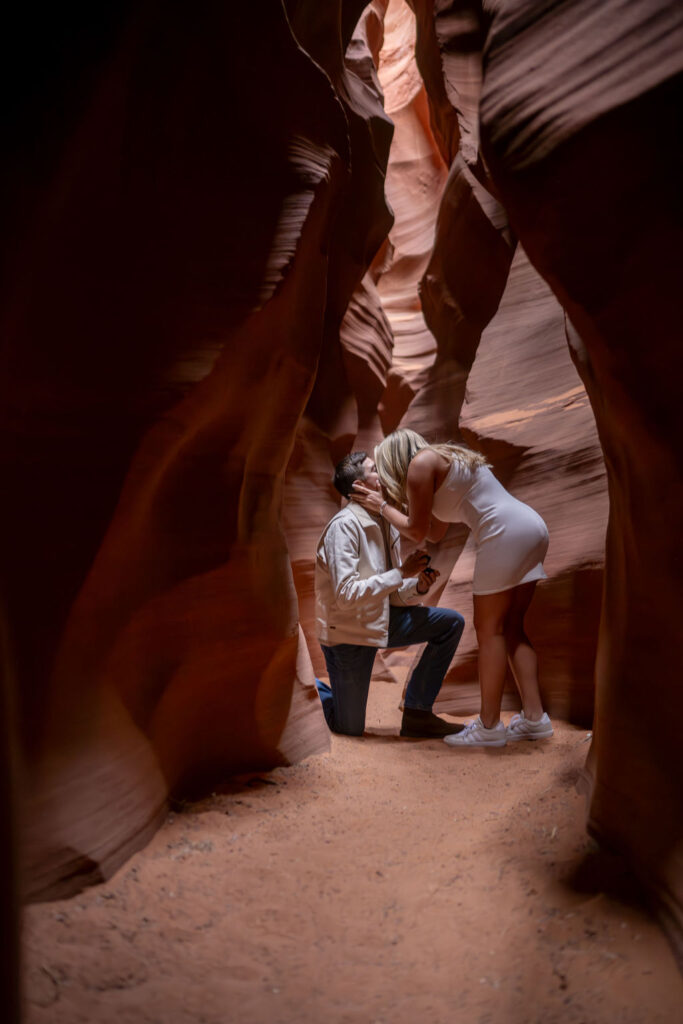 couple kisses during proposal at antelope canyon