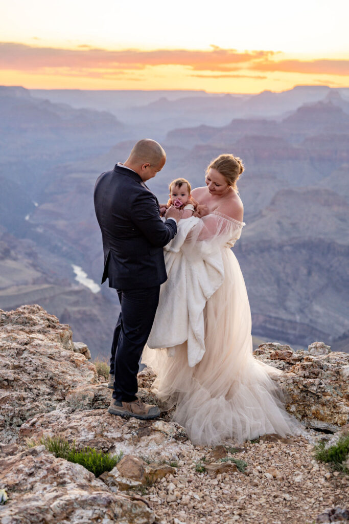 couple poses with daughter during Grand Canyon elopement
