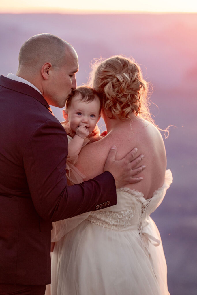 couple poses with daughter during Grand Canyon elopement