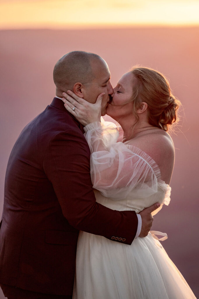 bride and groom kissing after ceremony