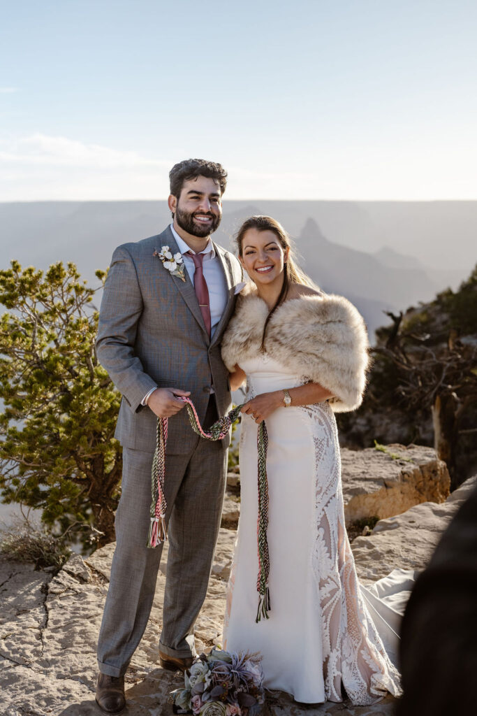 couple pose with tied rope symbolizing unity