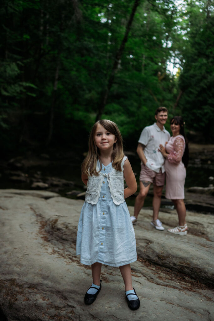 couple pose with their daughter