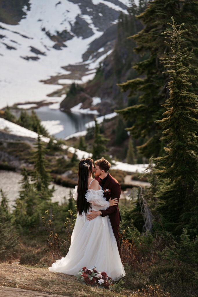 couple kiss among the trees in Washington state