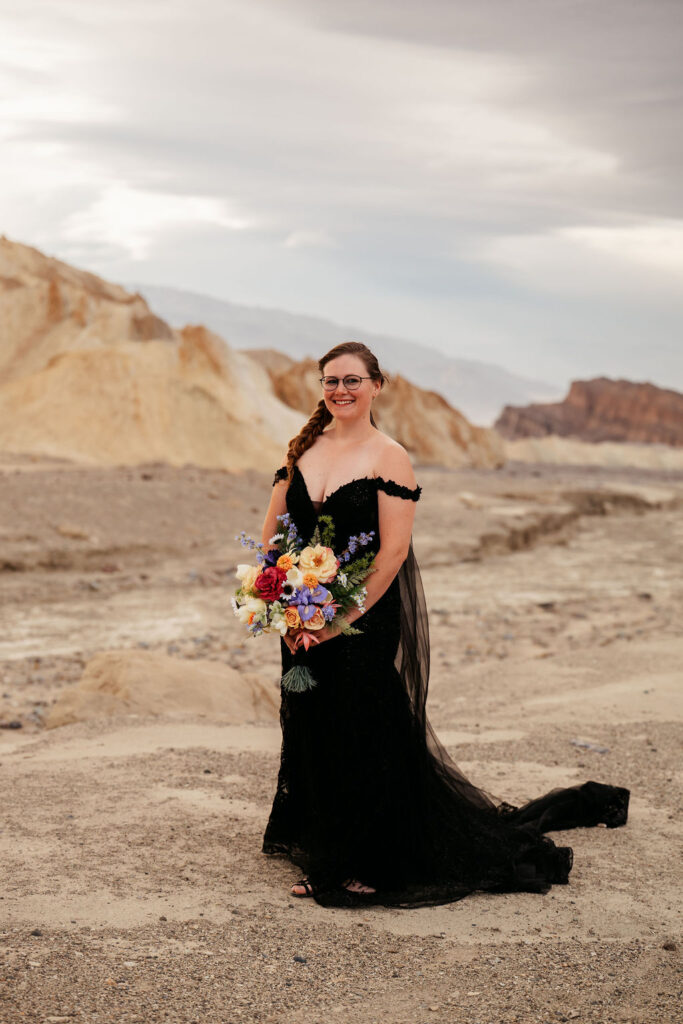 bridal portrait in black dress and colorful flowers