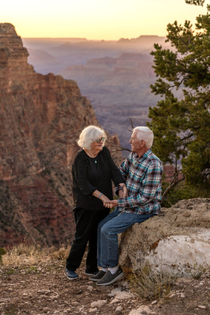 couple sitting on rocky ledge