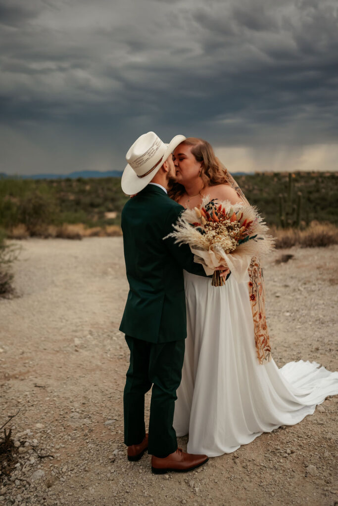 couple kiss after first look in Honey Bee Canyon Park