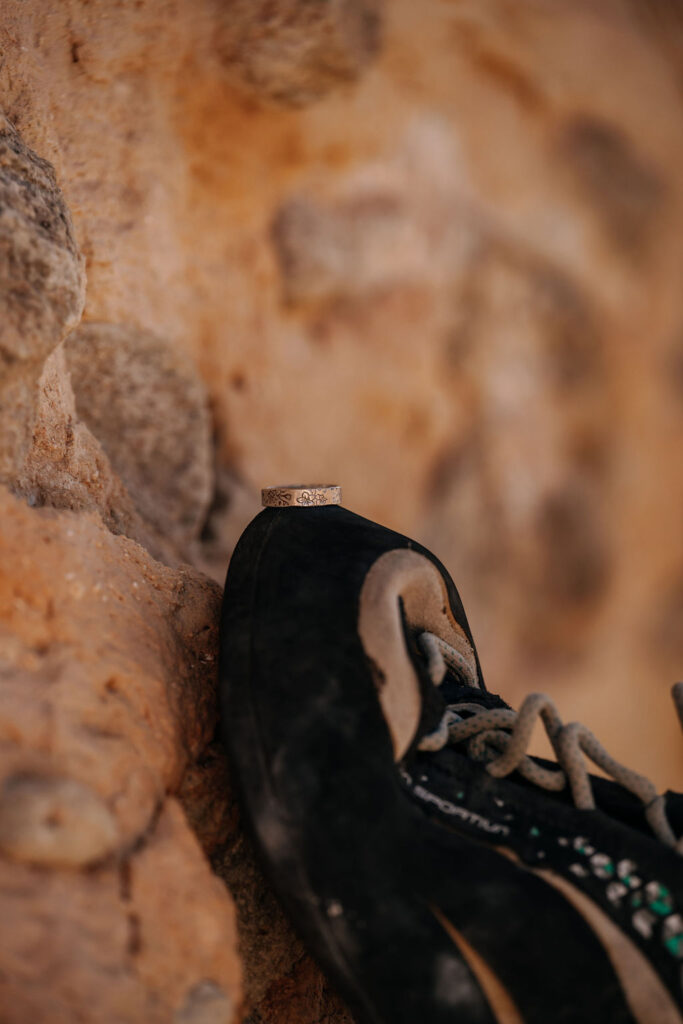 engagement rings sitting on climbing shoe