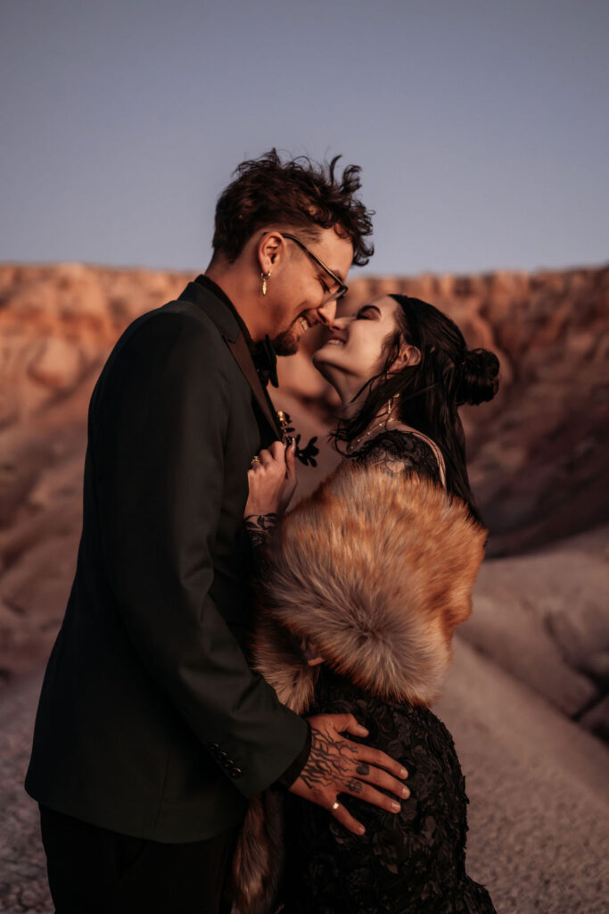 couple embrace overlooking Arizona painted desert