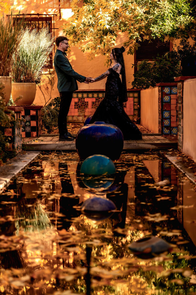 couple poses in front of the water at the La Posada hotel