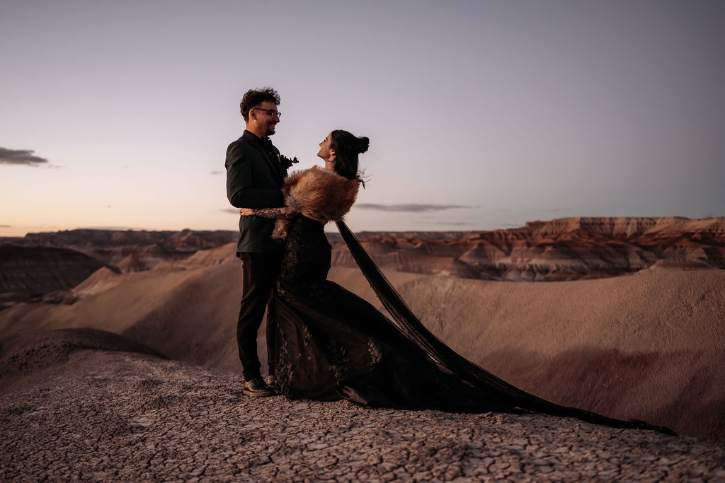 couple embrace overlooking Arizona painted desert