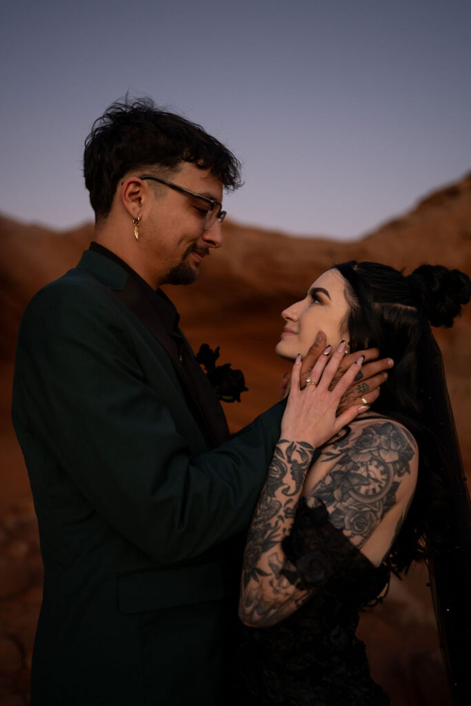 couple embrace in the sand caves as the sun sets