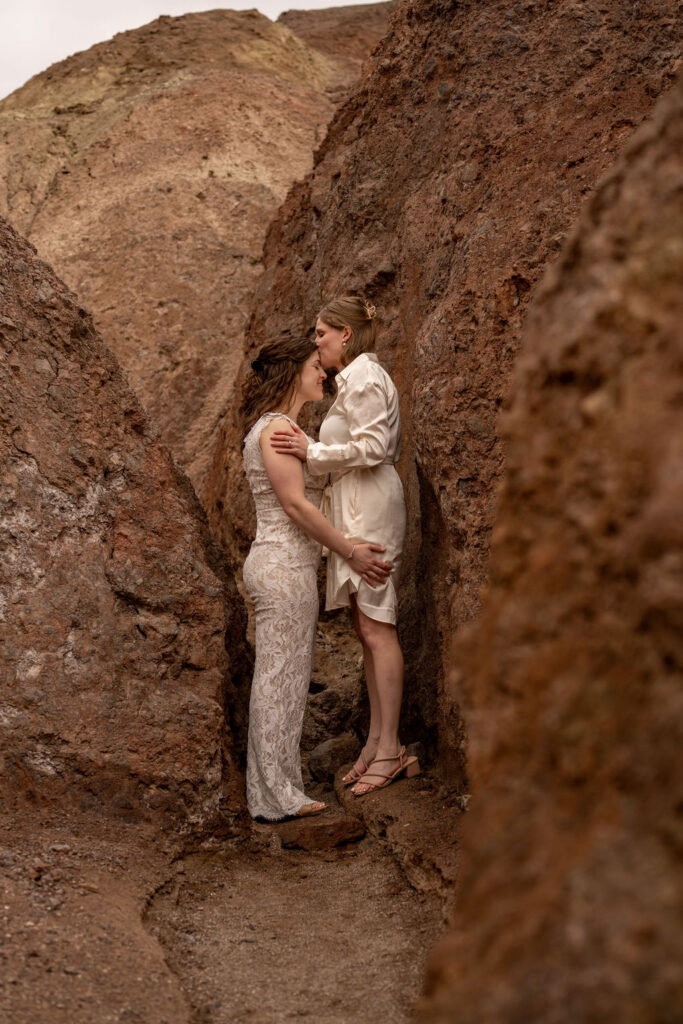 couple poses within the rocks during their death valley trip