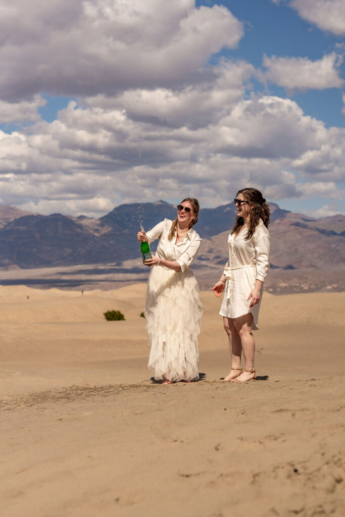 couple celebrates with champagne during their death valley trip