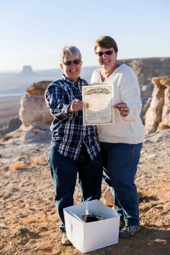 couple posing with marriage license