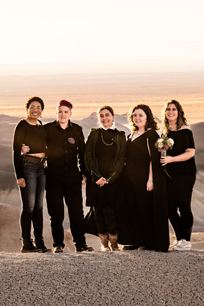 wedding party pose together for desert wedding