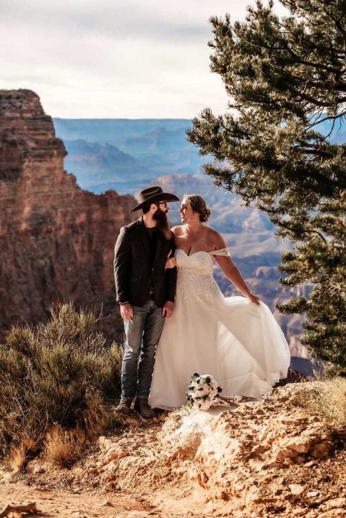 couple pose looking at each other with the Grand Canyon in the background