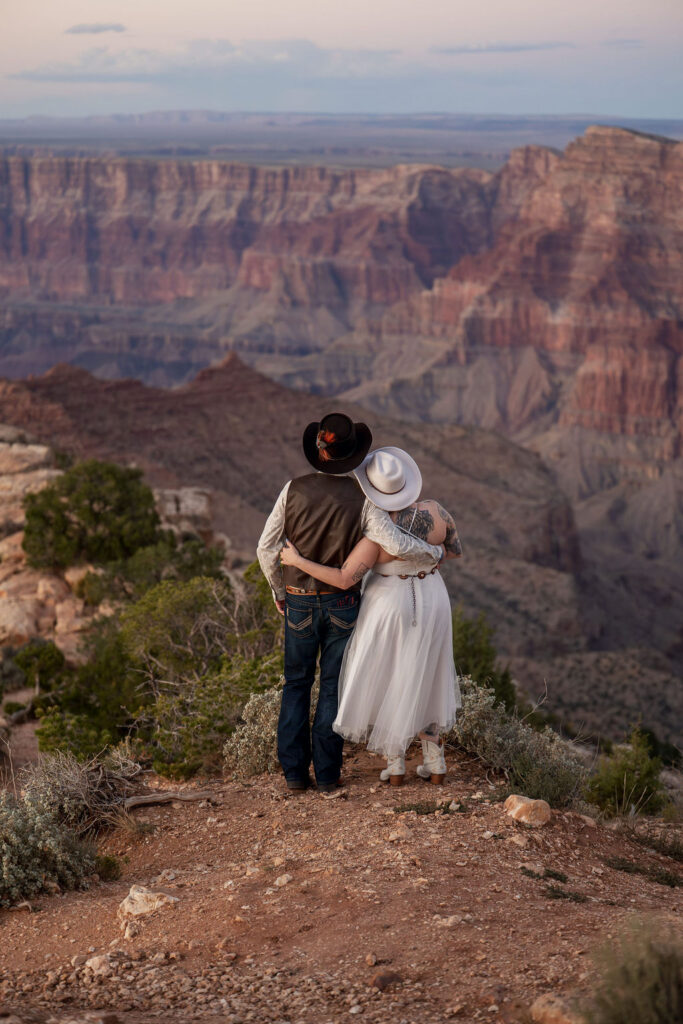 couple embrace overlooking the Grand Canyon