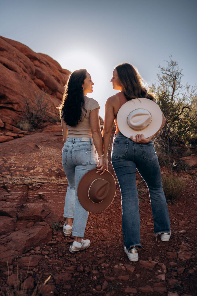 couple posing with cowboy hats at the Grand Canyon