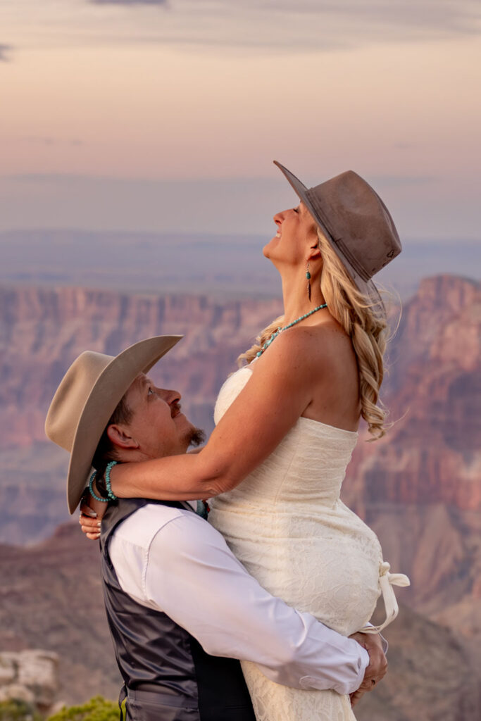man holds up woman and they are smiling