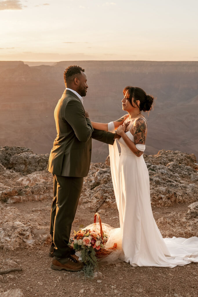 couple touch each other's heart during ceremony
