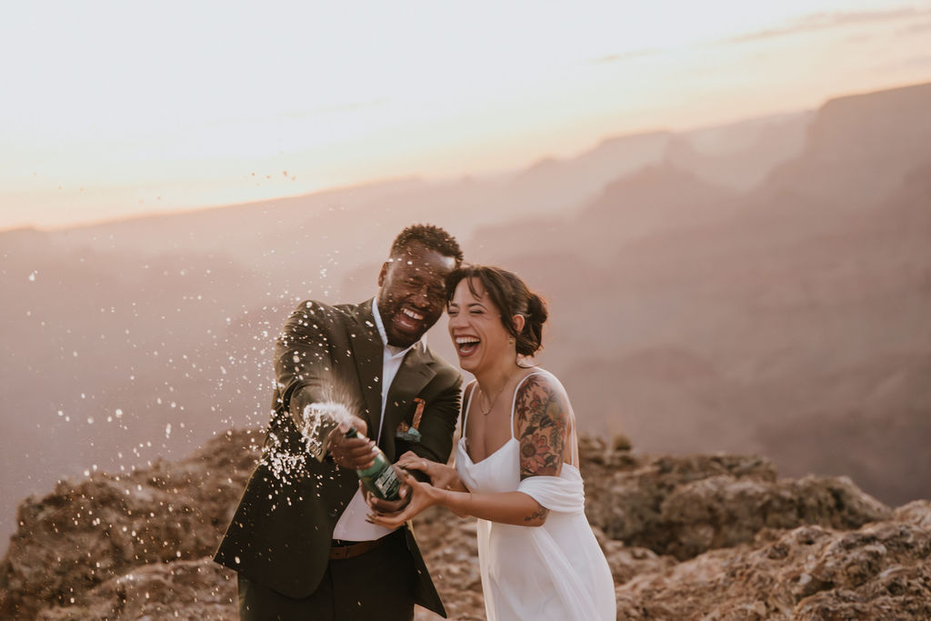 couple laugh and celebrate with champagne