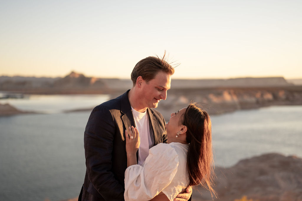 couple embrace by the water