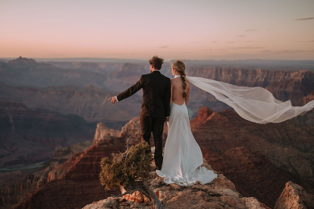 couple standing on edge at part of Grand Canyon adventure