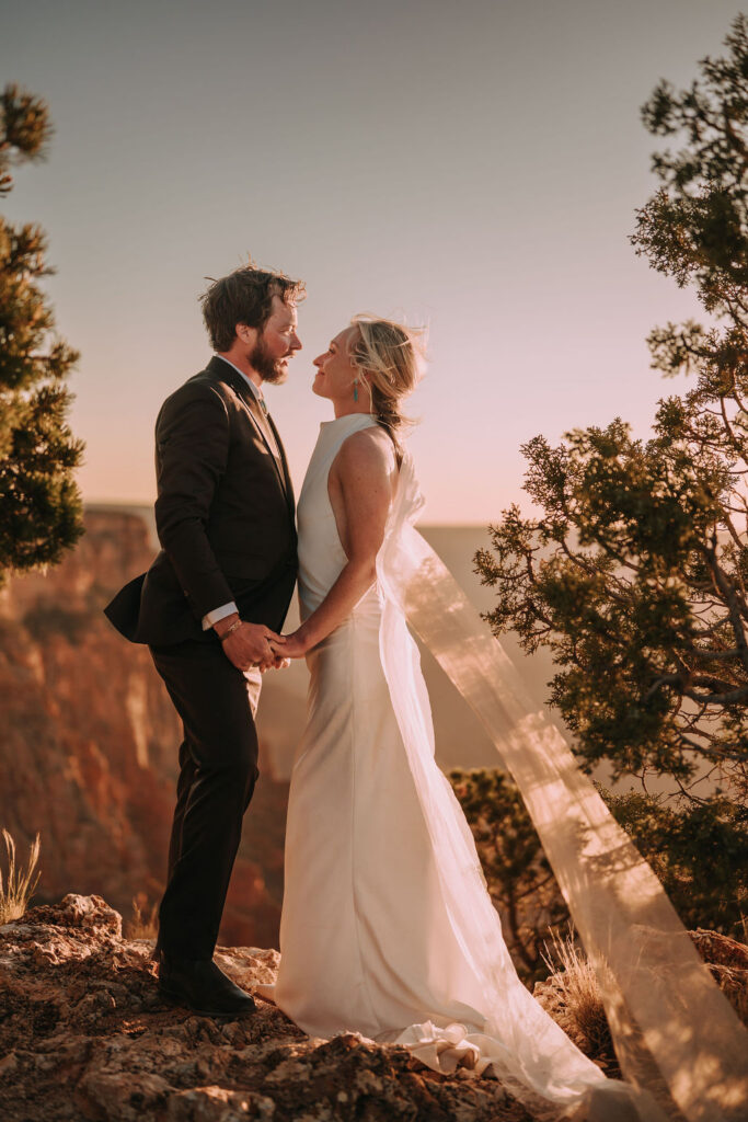 couple pose together at sunset as part of Grand Canyon adventure