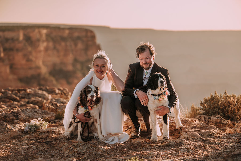 couple pose with their dogs