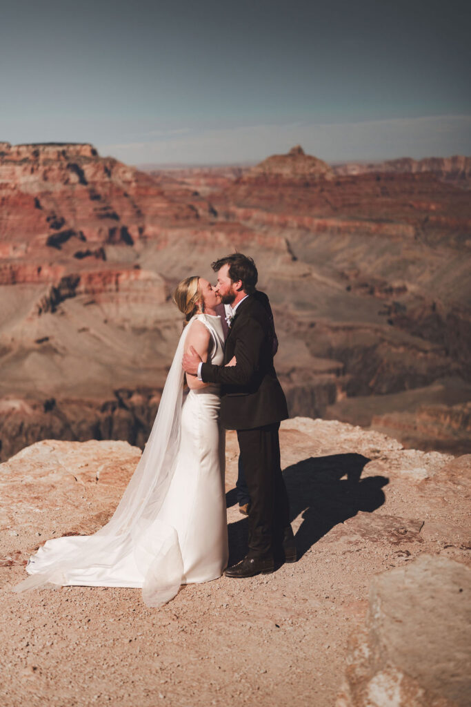couple kiss at ceremony as part of their Grand Canyon adventure
