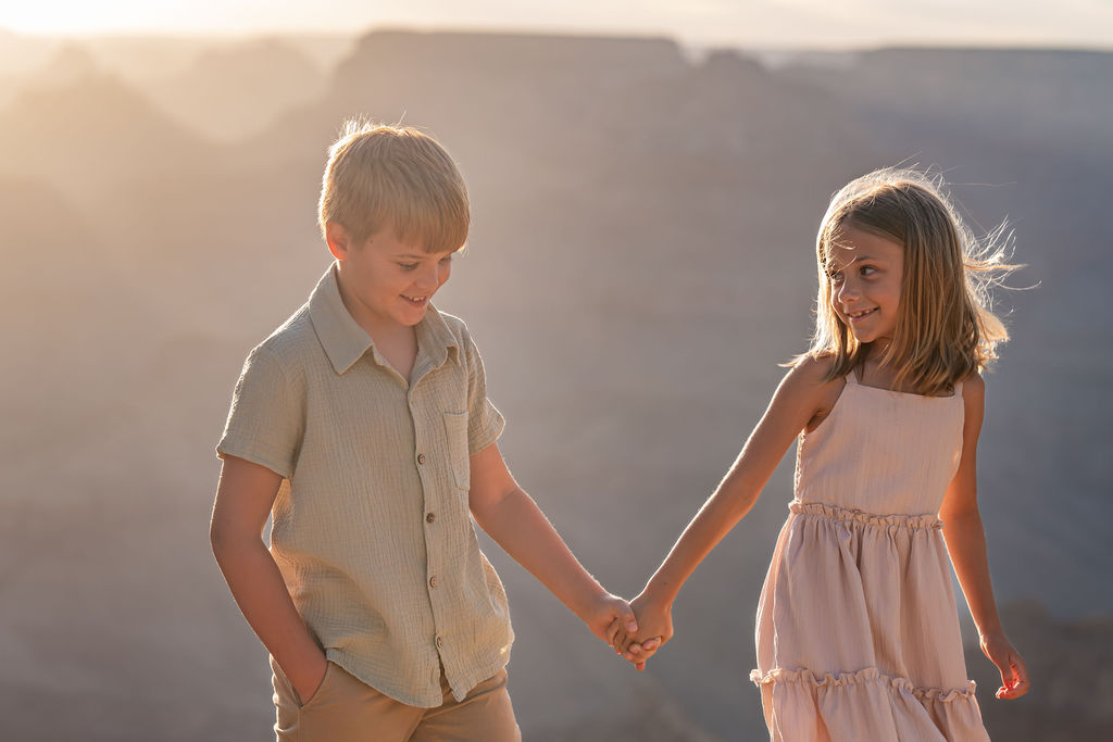 kids walking and holding hands at sunset