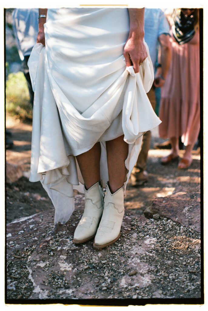 detail photo of wedding dress and boots