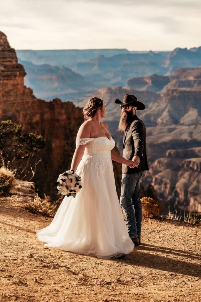 couple holds hands at Grand Canyon elopement