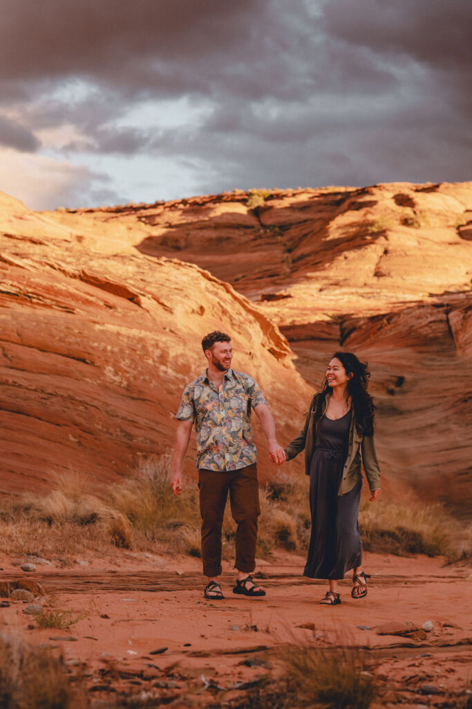 couple holds hands at Lake Powell engagement